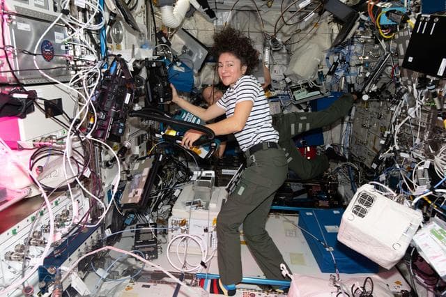 NASA image: Astronauts Jessica Meir and Chris Williams work together inside the Columbus laboratory module