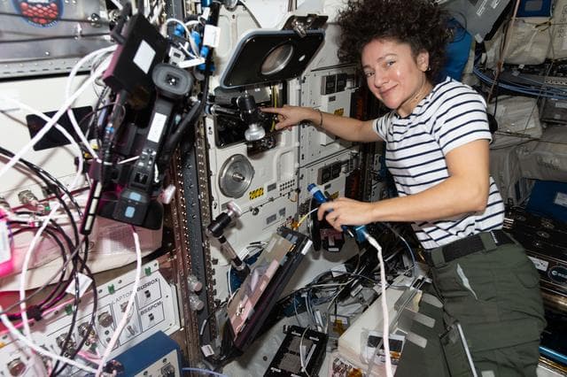 NASA image: Astronaut Jessica Meir swapps scientific hardware inside the BioLab research incubator