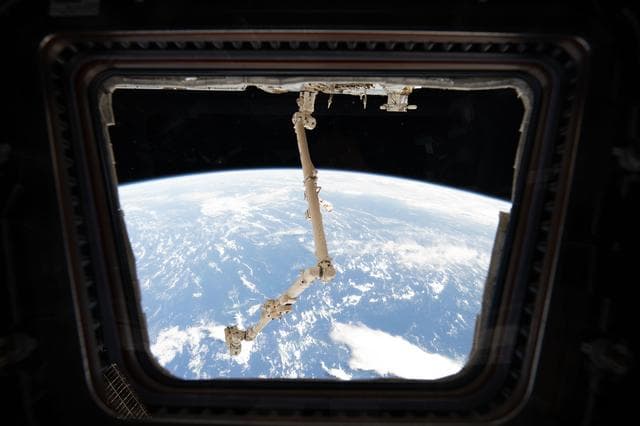 NASA image: The Canadarm2 robotic arm extends from the Harmony module