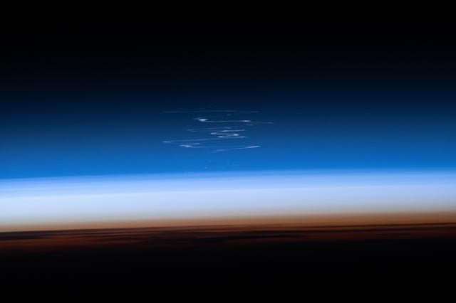 NASA image: The launch plume from a Progress 95 cargo spacecraft dispersing in the atmosphere