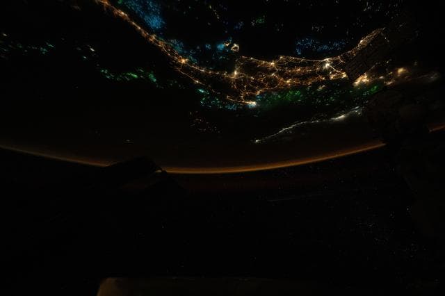 NASA image: The blue and green lights of fishing boats dot the Gulf of Thailand and the Andaman Sea