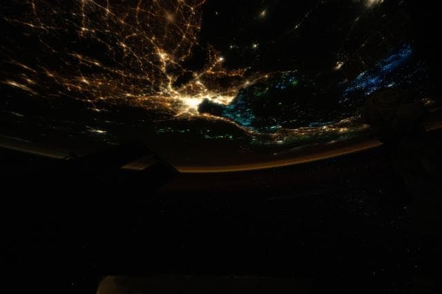 NASA image: The blue lights of fishing boats dot the Gulf of Thailand contrasting with the city lights of Bangkok