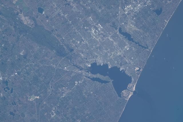 NASA image: Michigan’s Muskegon Lake flows into Lake Michigan