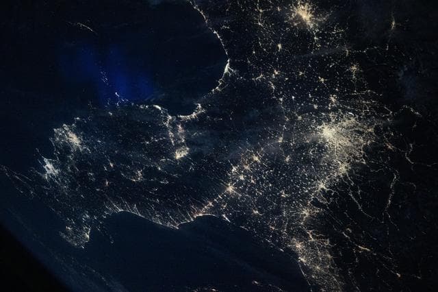 NASA image: Italy’s darkened Po Valley contrasts with the brighter city lights that surround the region