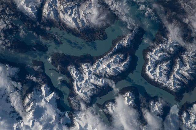 NASA image: Turquoise-blue waters of Lake Argentino surrounded by the snow-capped Andes Mountains