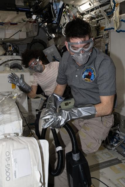 NASA image: NASA astronauts Jessica Meir and Jack Hathaway unpack temperature‑controlled scientific samples
