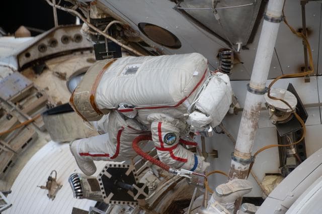 NASA image: Cosmonaut Sergey Kud-Sverchkov works outside the International Space Station in his Orlan spacesuit with red stripes