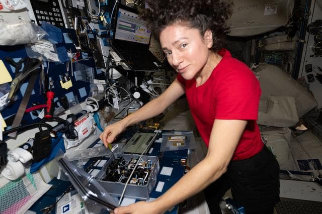 NASA image: NASA astronaut Jessica Meir removes components from inside the Advanced Space Experiment Processor‑4