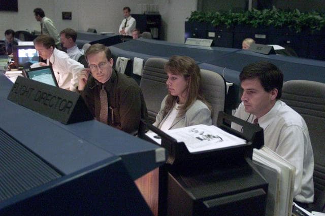 NASA image: STS-105 coverage of Mission Control Center employees in the WFCR & BFCR