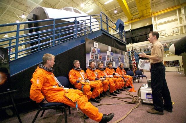 NASA image: STS-115 crew during crew bailout (91020) training in crew compartment trainer.