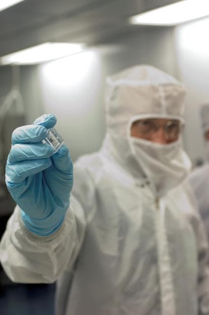 NASA image: Francois Robert receives a sample from the Stardust Experiment