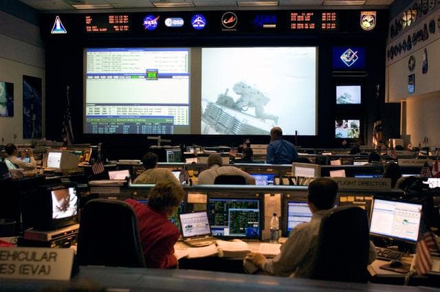 NASA image: Expedition 13 Flight Controllers on console during mission - Orbit 2 - BFCR during EVA