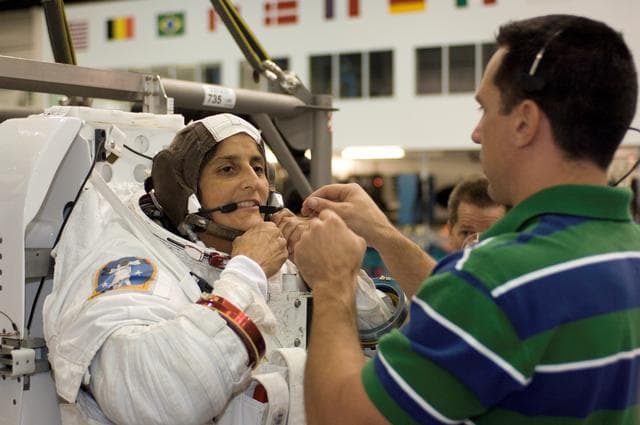 NASA image: STS-116 crew members during EVA training at the NBL.
