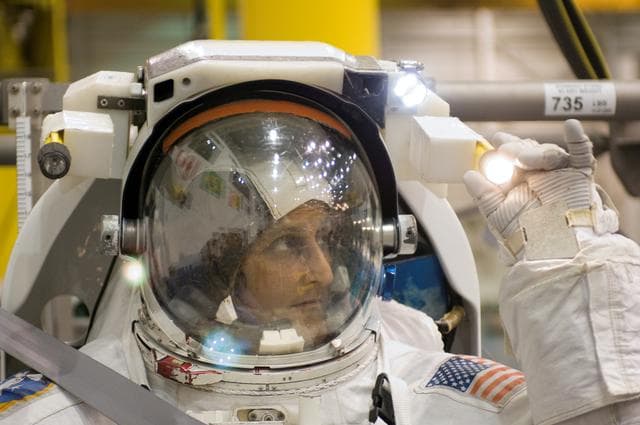 NASA image: STS-116 crew members during EVA training at the NBL.