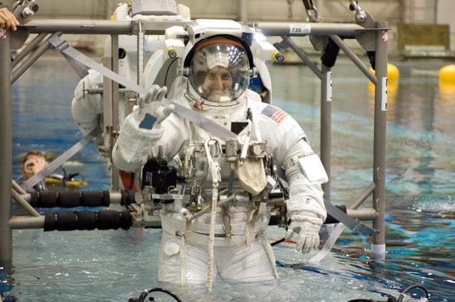 NASA image: STS-116 crew members during EVA training at the NBL.