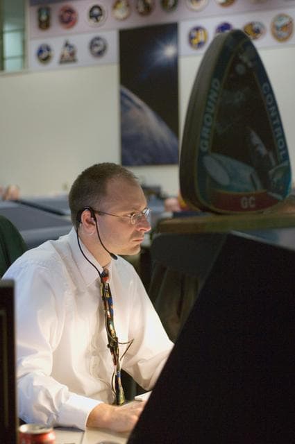 NASA image: STS-116 Flight Controllers on console during mission - Orbit 3, WFCR
