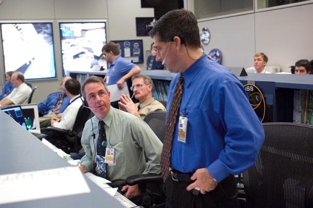 NASA image: STS-116/ISS 12A.1 flight controllers on console during EVA #4