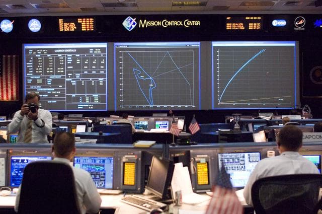 NASA image: STS-120 Flight Controllers on console during mission (Launch) - (Bldg. 30s, WFCR)