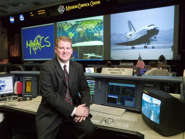 NASA image: STS-122 Flight Controller Justin Dithmer on Mechanical, Maintenance, Arm, and Crew Systems (MMACS) Console