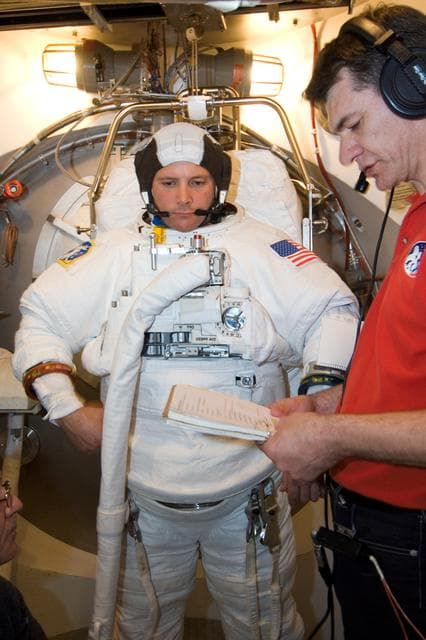 NASA image: STS-120 Preflight Training in the SSATA Airlock with Doug Wheelock