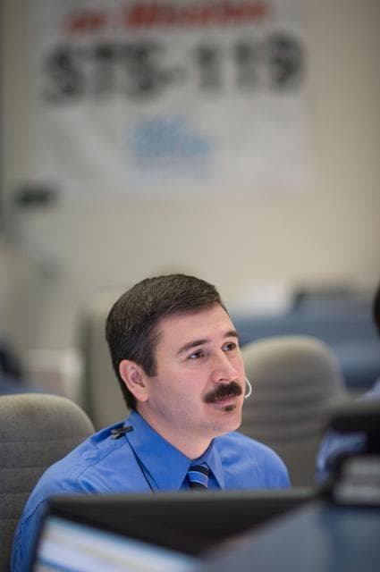 NASA image: STS-119 Flight Director Mike Sarafin and flight controllers on console during the undocking and fly around phase. 