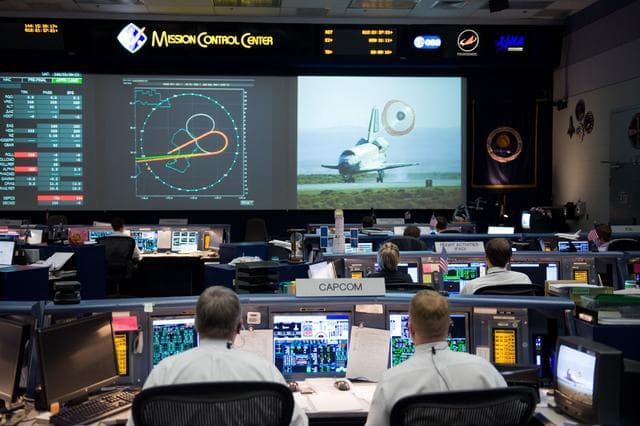 NASA image: STS-125 Entry flight controllers on console with Flight Director Norman Knight 
