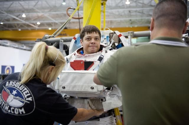 NASA image: STS-130 crew members George Zamka, Steve Robinson helping Robert Behnken and Nick Patrick 