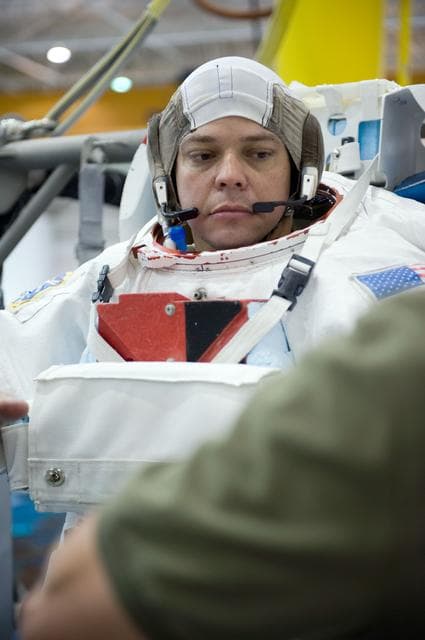 NASA image: STS-130 crew members George Zamka, Steve Robinson helping Robert Behnken and Nick Patrick 