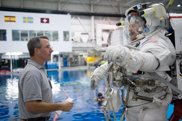 NASA image: STS-130 crew members George Zamka, Steve Robinson helping Robert Behnken and Nick Patrick 