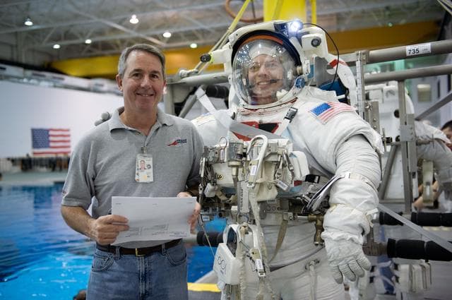 NASA image: STS-130 crew members George Zamka, Steve Robinson helping Robert Behnken and Nick Patrick 