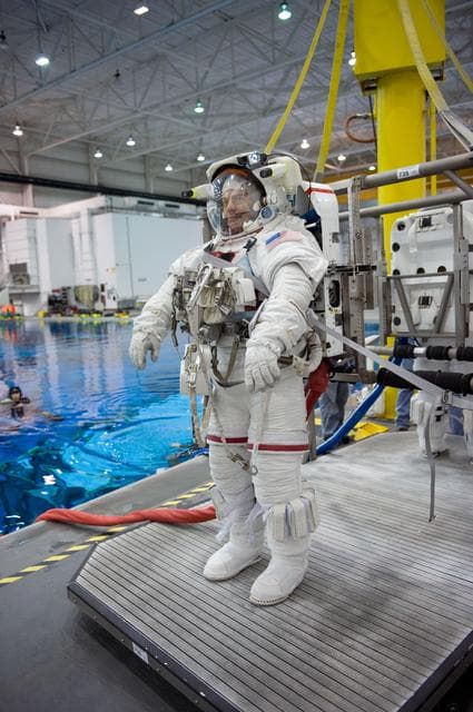 NASA image: STS-130 crew members George Zamka, Steve Robinson helping Robert Behnken and Nick Patrick 