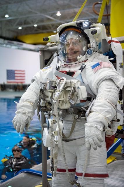 NASA image: STS-130 crew members George Zamka, Steve Robinson helping Robert Behnken and Nick Patrick 