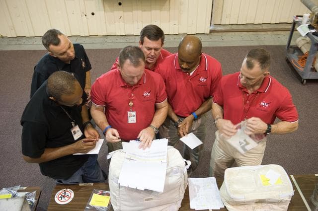 NASA image: STS-129 crew during trans hands-on review in the space station mockups.