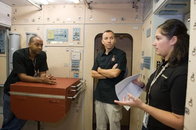 NASA image: STS-129 crew during trans hands-on review in the space station mockups. 