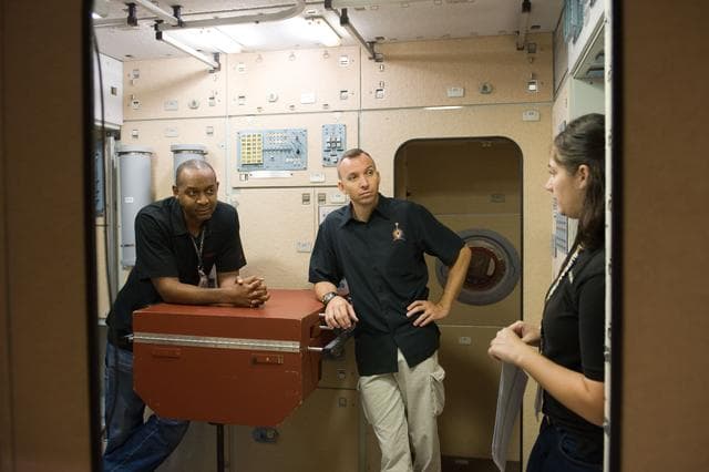 NASA image: STS-129 crew during trans hands-on review in the space station mockups. 