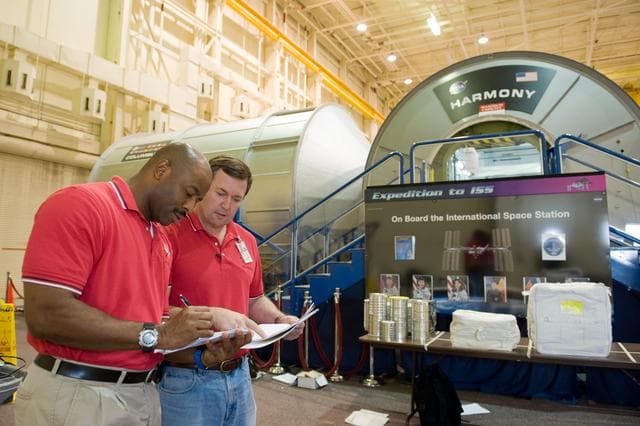 NASA image: STS-129 crew during trans hands-on review in the space station mockups. 