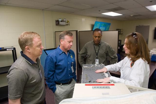 NASA image: STS-133 crew members Lindsey, Boe and Drew during Tool/Repair Kits training with instructor
