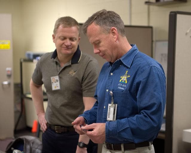 NASA image: STS-133 crew members Lindsey, Boe and Drew during Tool/Repair Kits training with instructor 