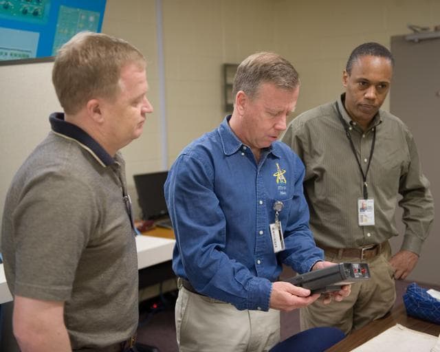 NASA image: STS-133 crew members Lindsey, Boe and Drew during Tool/Repair Kits training with instructor 