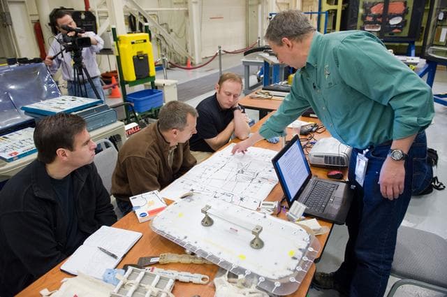 NASA image: STS-134 crew members Mike Fincke, Drew Feustel and Greg Chamitoff performing EVA Tile Repair Training. 