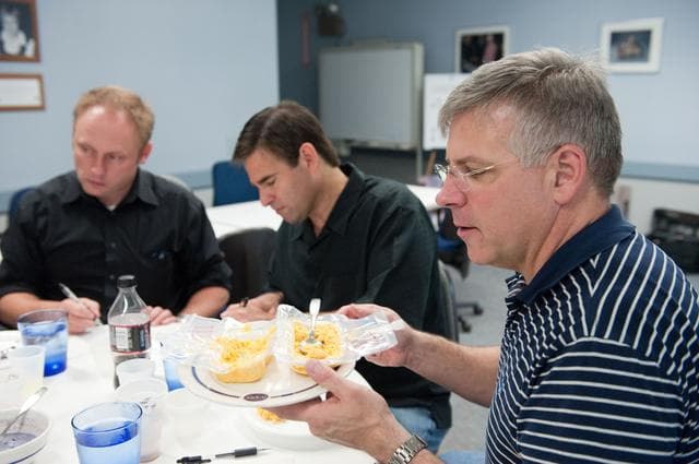 NASA image: STS-134 crew during food tasting session in JSC Food Lab.