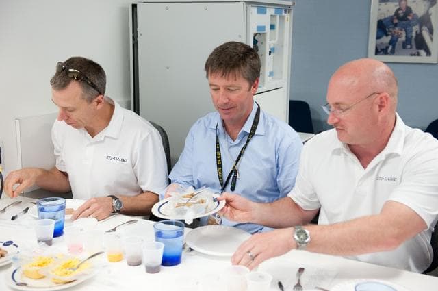 NASA image: STS-134 crew during food tasting session in JSC Food Lab.