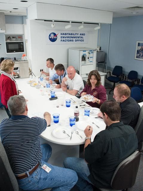 NASA image: STS-134 crew during food tasting session in JSC Food Lab.
