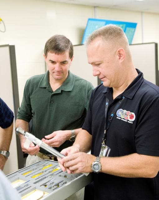 NASA image: STS-335 crew training, Tool/Repair Kits with instructor Jeff Stone   