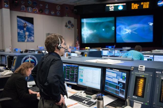 NASA image: ISS Orbit 2 flight controllers on console with Flight Director Bob Dempsey    