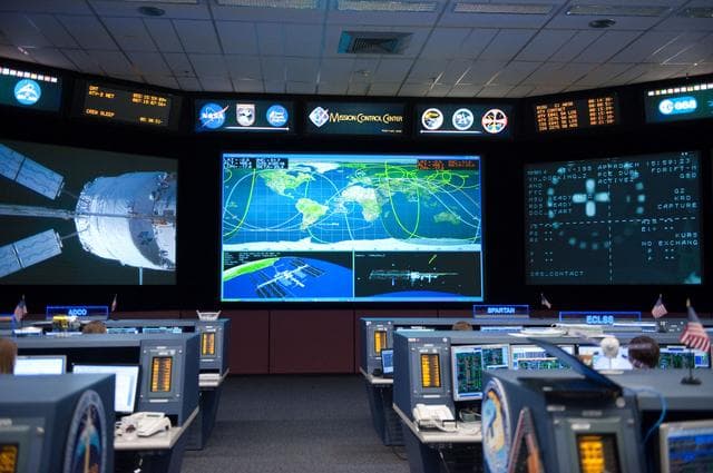 NASA image: ISS Orbit 2 flight controllers on console with Flight Director Bob Dempsey    