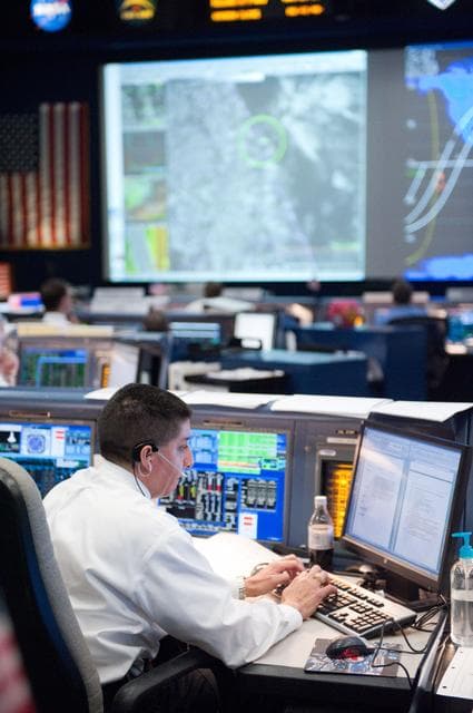 NASA image: STS-133 flight controllers on console during the launch of Discovery   