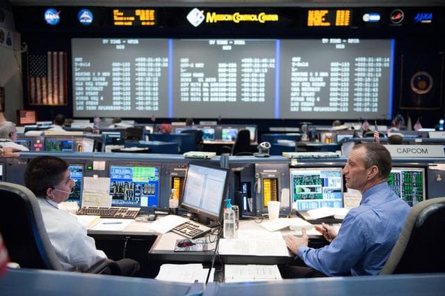 NASA image: STS-133 flight controllers on console during the launch of Discovery   