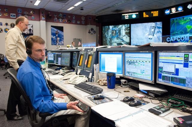 NASA image: STS133/ULF5 Flight Controllers on Console - Orbit 1
