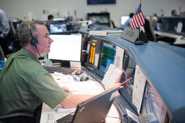 NASA image: STS-133/ULF5 Orbit 1 flight controllers on console during unberth of Permanent Multipurpose Module (PMM) from shuttle.   